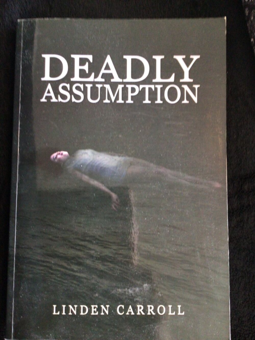 Deadly Assumption by Linden Carroll, signed by the author